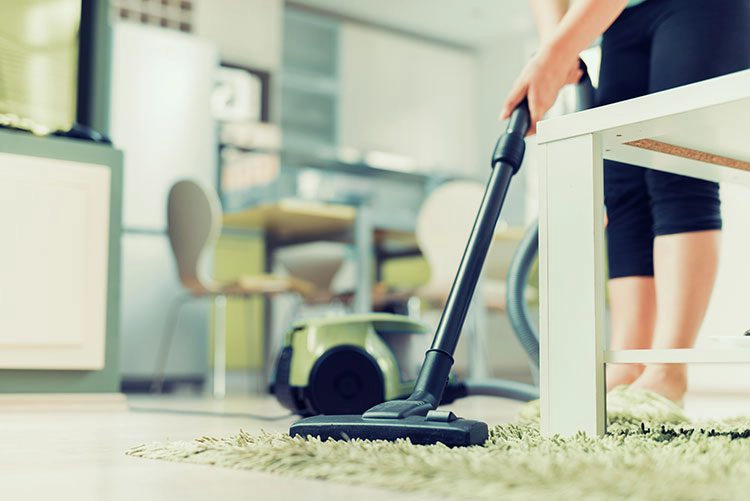 woman vacuuming carpet