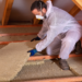 How to Clean Up after a Rodent Infestation - man laying thermal insulation in attic