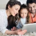 Enjoy a Rodent-Free Home for Good - happy family on floor of home looking at tablet